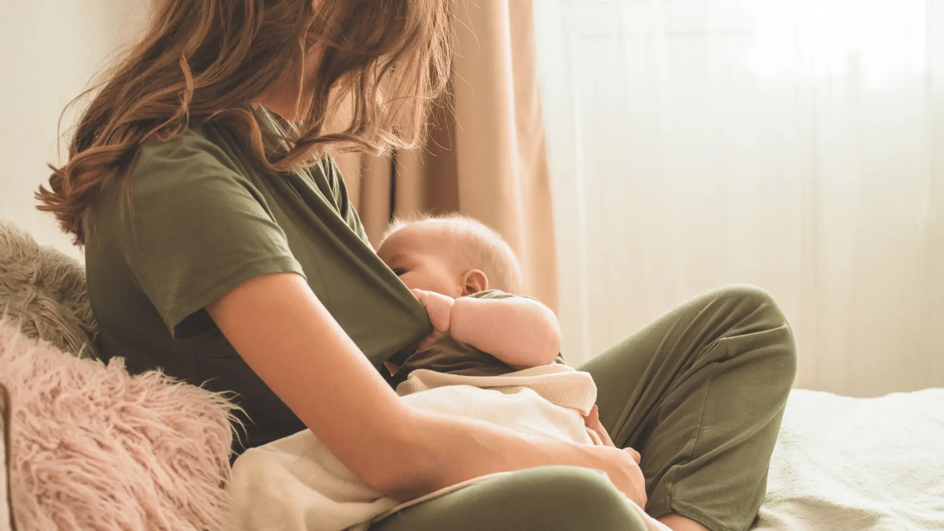 Lactation consultant helping new mother with breastfeeding pain and positioning
